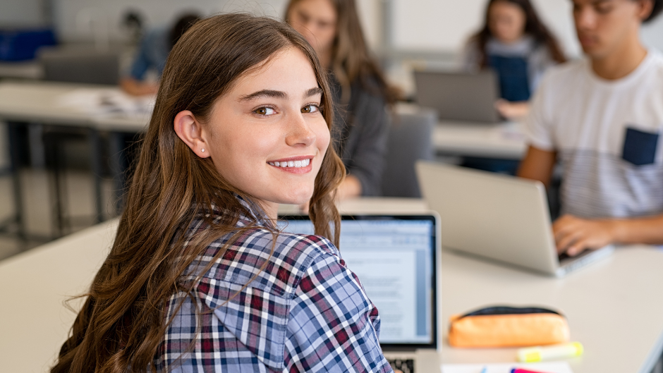 a imagem mostra uma menina na aula da faculdade